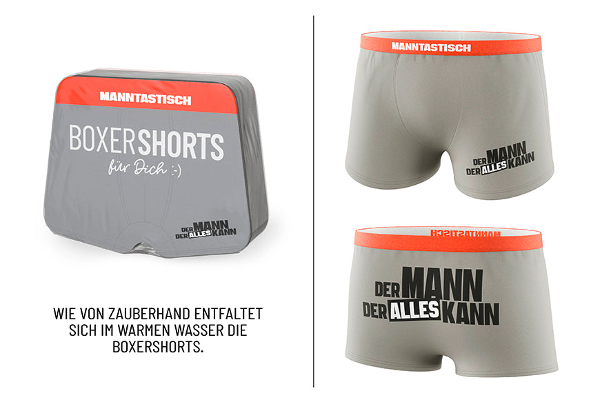 Magische Boxershorts „Der Mann der alles kann“ – graue Shorts mit rotem Bund, Spruch vorne & hinten, Größe L, von Geschenk für Dich