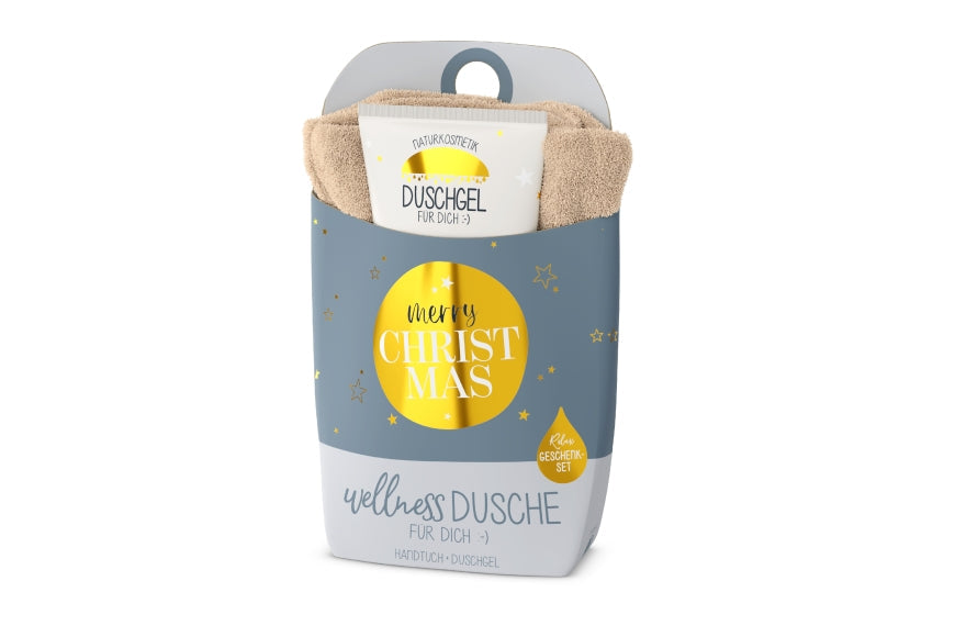 Wellnessdusche „Merry Christmas“ – Handtuch &amp; Naturkosmetik-Duschgel in grauer Verpackung mit goldenem Kreis und Sternen