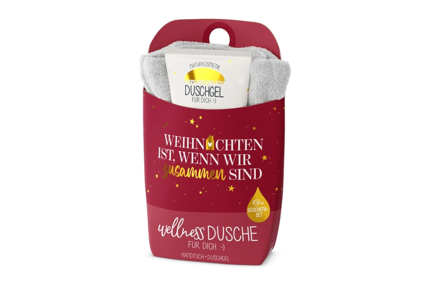 Wellnessdusche „Weihnachten ist, wenn wir zusammen sind“ – Handtuch &amp; Naturkosmetik-Duschgel in roter Verpackung mit goldenen Sternen
