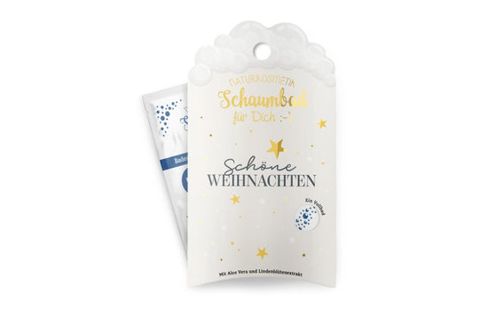 Naturkosmetik-Schaumbad „Schöne Weihnachten“ in weißer Verpackung mit goldenen Sternen