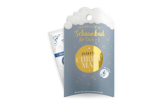 Naturkosmetik-Schaumbad „Merry Christmas“ in grauer Verpackung mit goldenem Kreis und Sternen