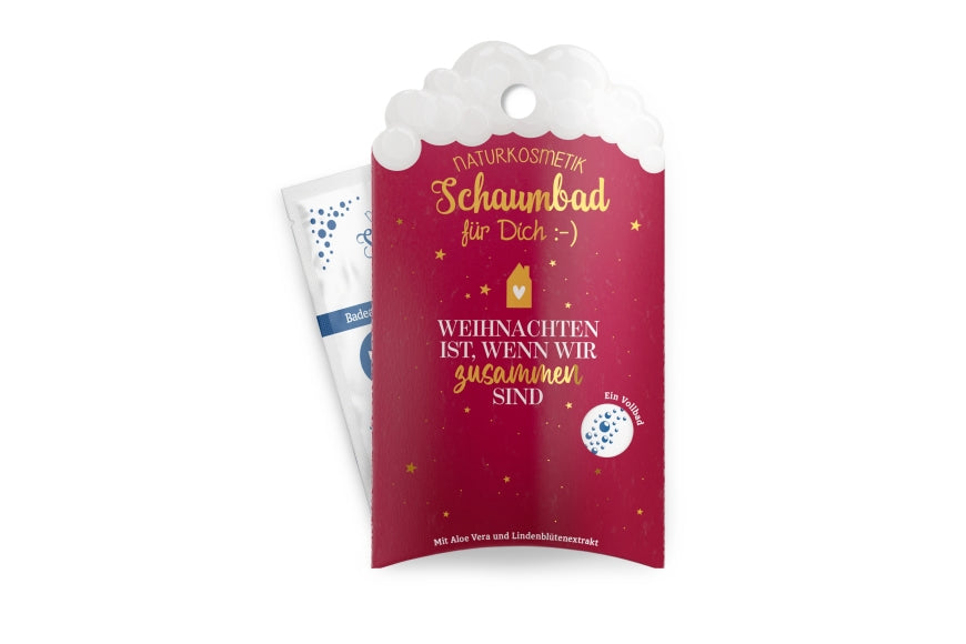 Naturkosmetik-Schaumbad „Weihnachten ist, wenn wir zusammen sind“ in roter Verpackung mit goldenen Sternen