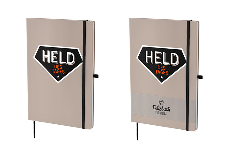 Beiges Hardcover-Notizbuch „Held des Tages“ mit 96 linierten Seiten, Lesezeichen & Stiftehalter von Geschenk für Dich