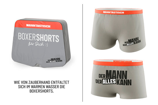Magische Boxershorts „Der Mann der alles kann“ – graue Shorts mit rotem Bund, Spruch vorne & hinten, Größe L, von Geschenk für Dich
