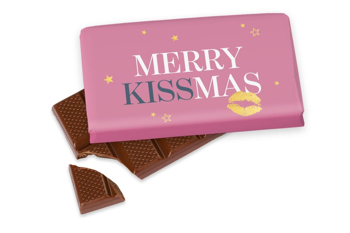 Weihnachtsschokolade mit Spruch Merry Kissmas, rosa mit goldenem Kussmund und Sternen, Vollmilch 40 g – Geschenk für Dich