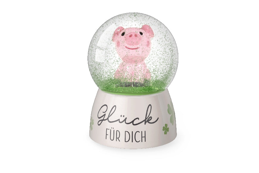 Glitzerkugel „Glück für Dich“ mit hellrosa Sockel & Kleeblättern. Glücksschweinchen in der Kugel von Geschenk für Dich.
